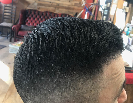 Bruno, cutting hair on the seaside in Porthleven, Cornwall