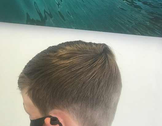 Bruno, cutting hair on the seaside in Porthleven, Cornwall