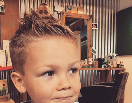 Bruno, cutting hair on the seaside in Porthleven, Cornwall