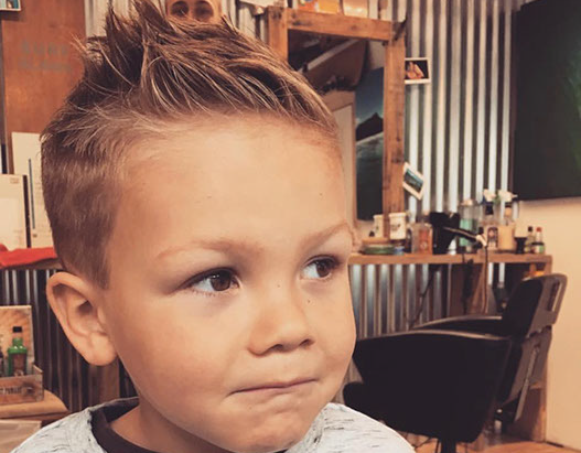 Bruno, cutting hair on the seaside in Porthleven, Cornwall